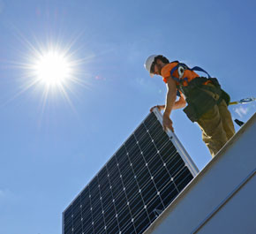 Crew member from Altenergy Inc. installs a solar panel