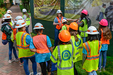 Several girls attend a tour of the Memorial for Enslaved Laborers construction zone during Girls Day 2019