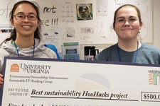 Electrical engineering majors Emily Flynn and Colleen Foley hold an oversized check for 500 dollars, their prize from U.V.A. Sustainable I.T. for best sustainability HooHacks project