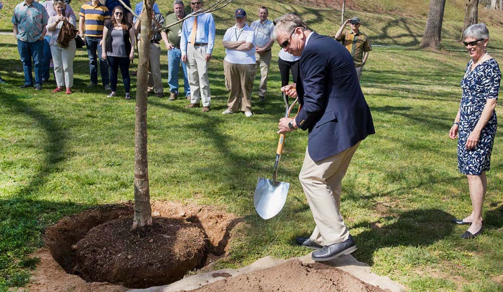 Jeff Sitler plants a tree as part of the annual Founder's Day ceremony