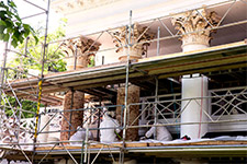 University masons strip the portland-cement stucco from the columns in front of Pavilion III