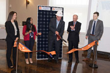 Governor McAuliffe cutting a symbolic ribbon for the solar array