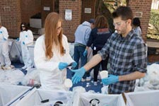 Engineering students sort through trash during a waste stream inventory