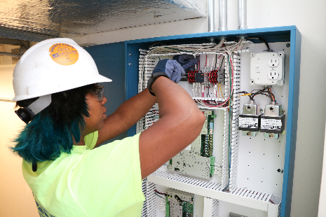 Rona Rose working on an electrical panel