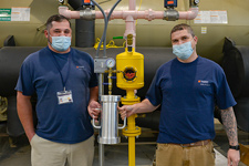 Jonathan Ragland and Dusty Buck holding a vacuum chamber