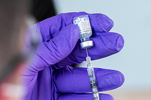 Close-up view of a syringe being filled with a vaccine