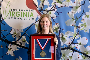 Lela Garner holding a framed award