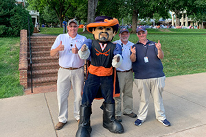 Facilities Management employees stand with the Cav Man mascot
