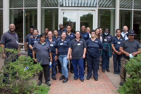 The E&G Custodial team in a group photo outdoors