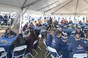 Photo of several FM employees eating at round tables during the FM Appreciation Lunch