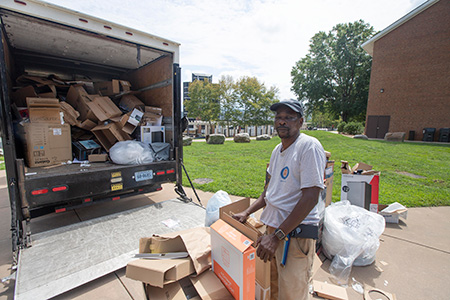 FM employee breaking down cardboard boxes