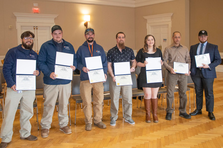 2023's apprenticeship program graduates display their certificates