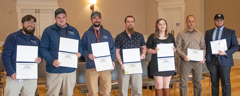 2023's apprenticeship program graduates display their certificates