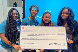 Students hold up an oversized check