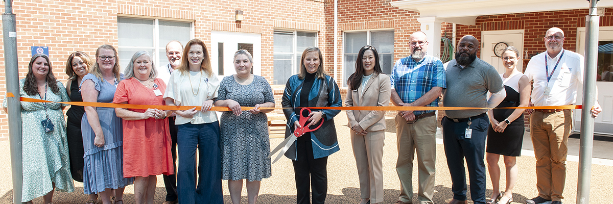 A group of UVA Health and Facilities Management employees at a ribbon cutting event