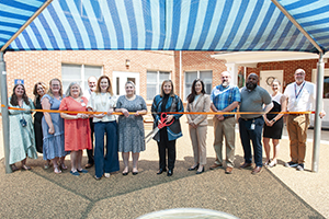 A group of UVA Health and Facilities Management employees at a ribbon cutting event