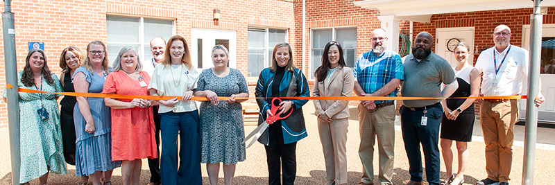 A group of UVA Health and Facilities Management employees at a ribbon cutting event