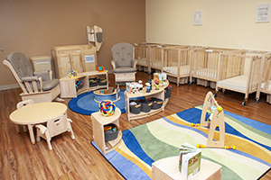 New infant room with cribs and infant-sized furniture