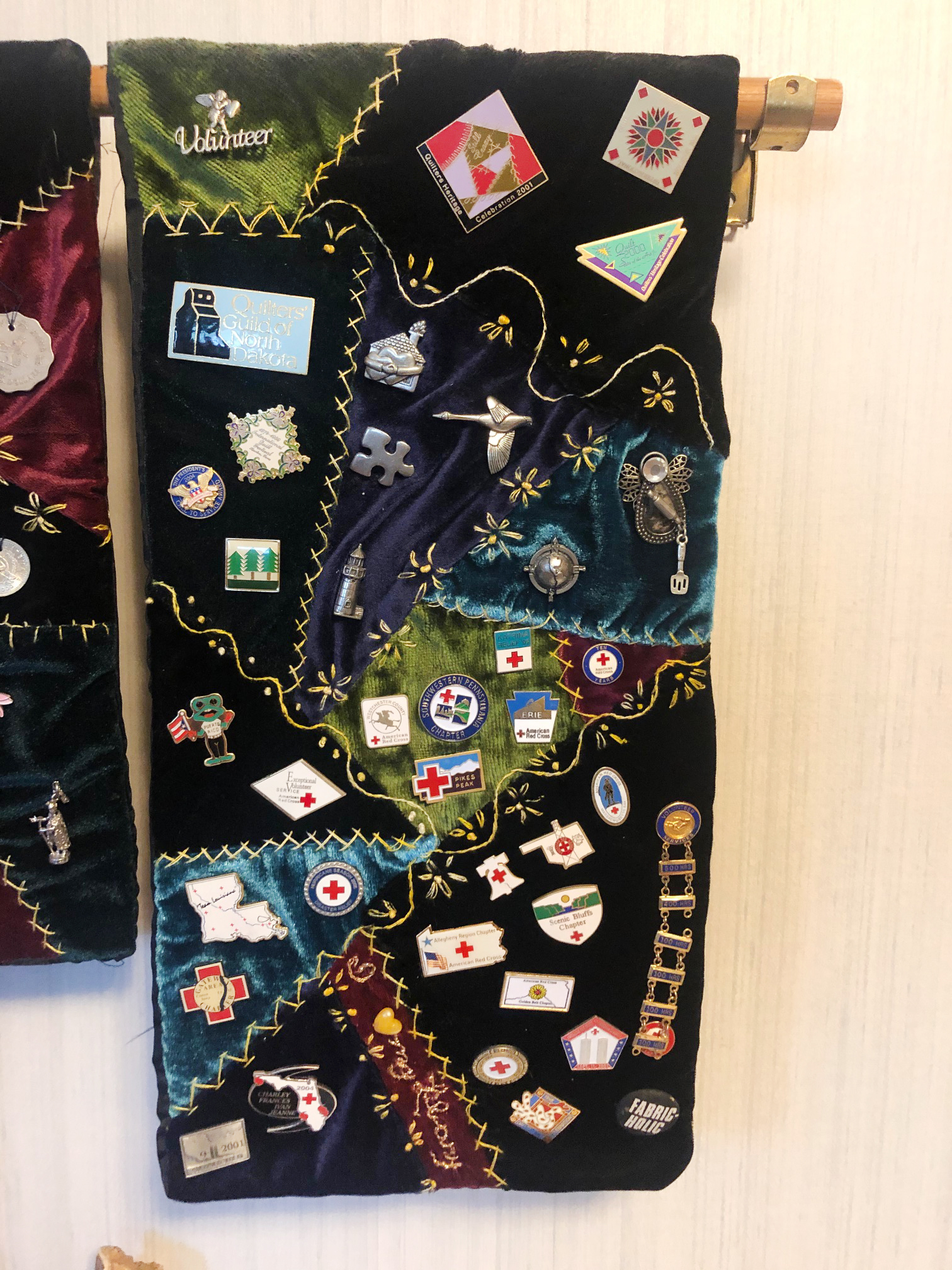 A quilt made by Shelomith Gonzalez's grandmother, adorned with numerous pins from donating blood