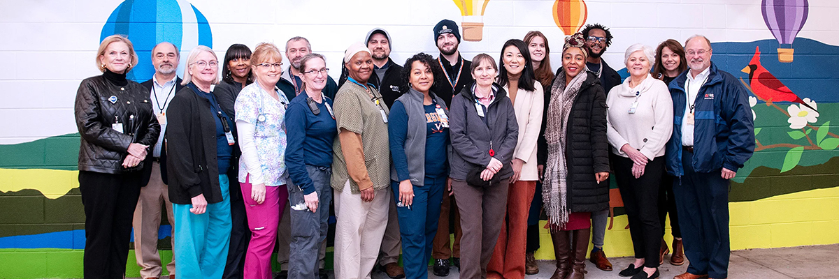 UVA employees and community members in front of an 11th St. Garage mural