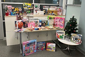 Toy donations piled on tables and desks