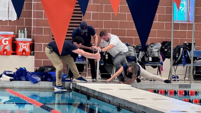Staff members work together to adjust swim lanes