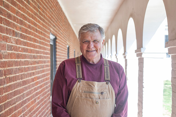 John Sauer stands in a pavilion walkway