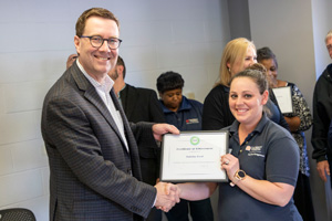 Green Seal CEO Doug Gatlin presents a certificate to Tabitha Ford
