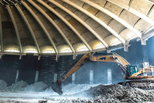 An excavator inside the demolished interior of University Hall