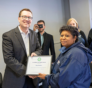 FM employee Mary Booker receives an award from Doug Gatlin