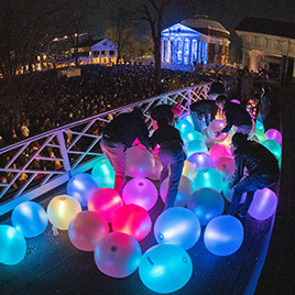 Students prepare to throw light balls to the crowd at Lighting of the Lawn.