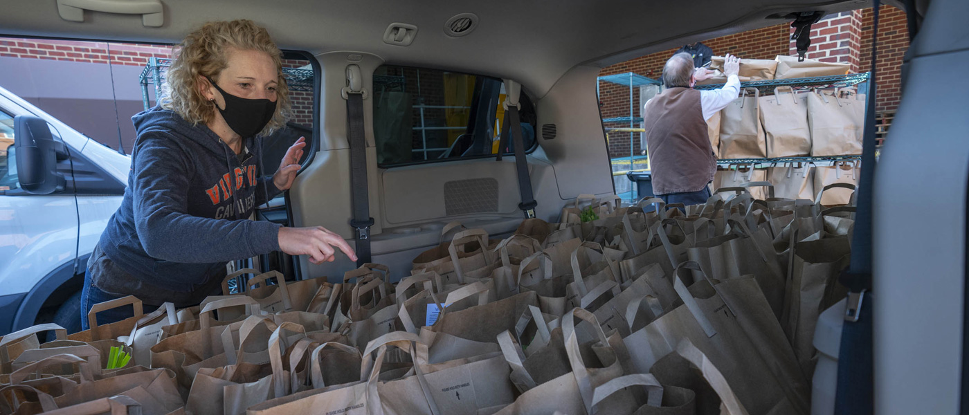 An FM employee takes stock of a van full of grocery bags