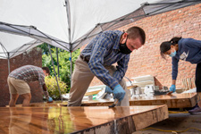 Mark Kutney applying epoxy to a wooden table