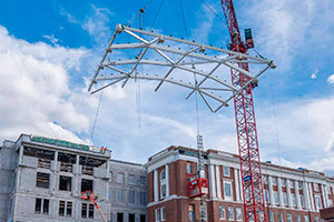 A skylight frame being hoisted by a crane