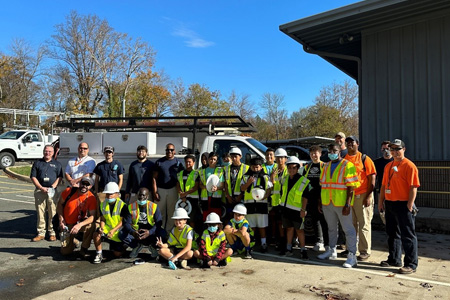 A group photo of Boys and Girls Club visitors and Facilities staff