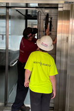 Young man being shown the inner workings of an elevator