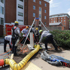 Firefighters conducting a rescue training exercise within a utility tunnel