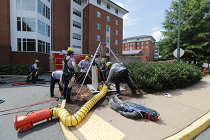 Firefighters conducting a rescue training exercise within a utility tunnel