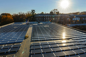 Solar panel array on a roof under a clear sunny sky