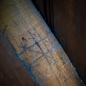 A hexfoil pattern carved into a wood beam