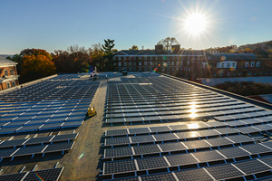 An array of solar panels on a roof on a sunny day