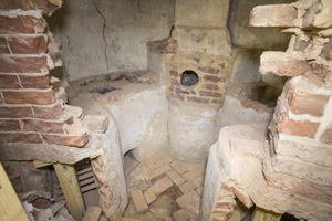 A chemical hearth, revealed behind an antique brick wall