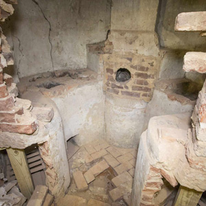 A chemical hearth, revealed behind an antique brick wall