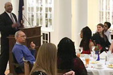 Custodial Services worker Michael Minor speaks to the crowd at student dinner