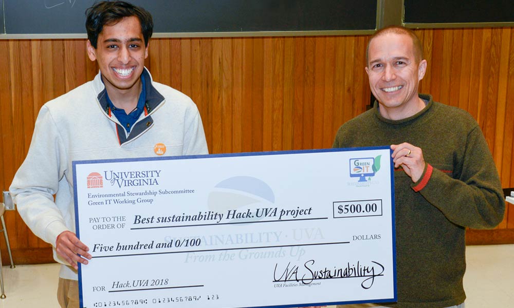 Chris Smeds presents Yash Jain with a $500 check for Best sustainability Hack UVA project