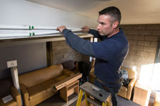 James Thornton, of Lakeside Electric of Louisa, changes out fluorescent light tubes.