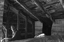 Peter Giscombe, a UVA graduate student peers into an attic on the Lawn