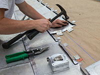 Facilities Management employee installs new-old roof on Hotel D.