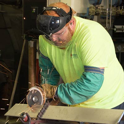 Utilities Pipefitter/Steamfitter Josh Berthod cuts a piece of angle iron to support the new hot well tank