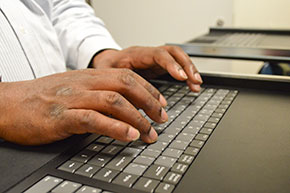 Employee typing on server keyboard